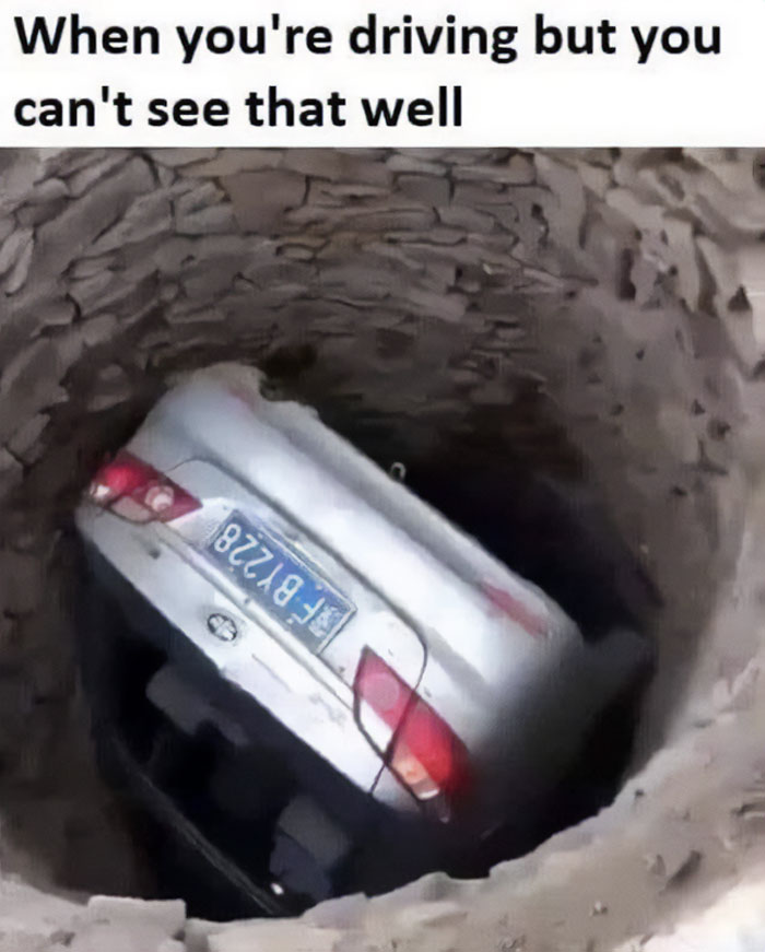 Car stuck upside down in a deep hole, showcasing a funny example of bad drivers from a popular Facebook group.