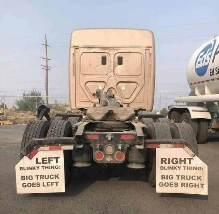 Rear view of a truck with humorous signs explaining the left and right turn signals for bad drivers awareness.