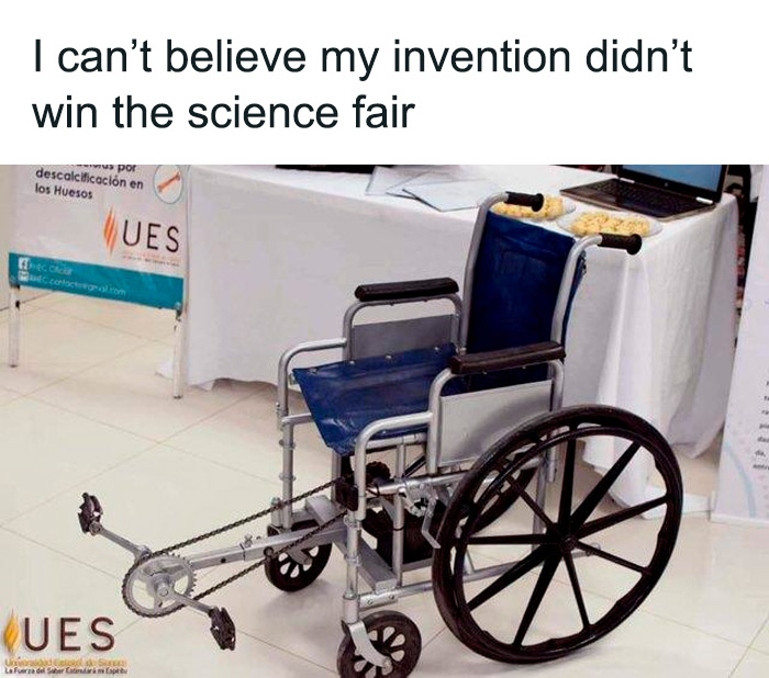 Wheelchair with pedals invention at a science fair, representing funny science jokes and memes about creativity.