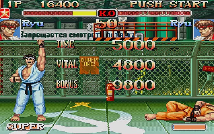 Retro video game scene with martial arts fighter celebrating victory in an arcade setting.