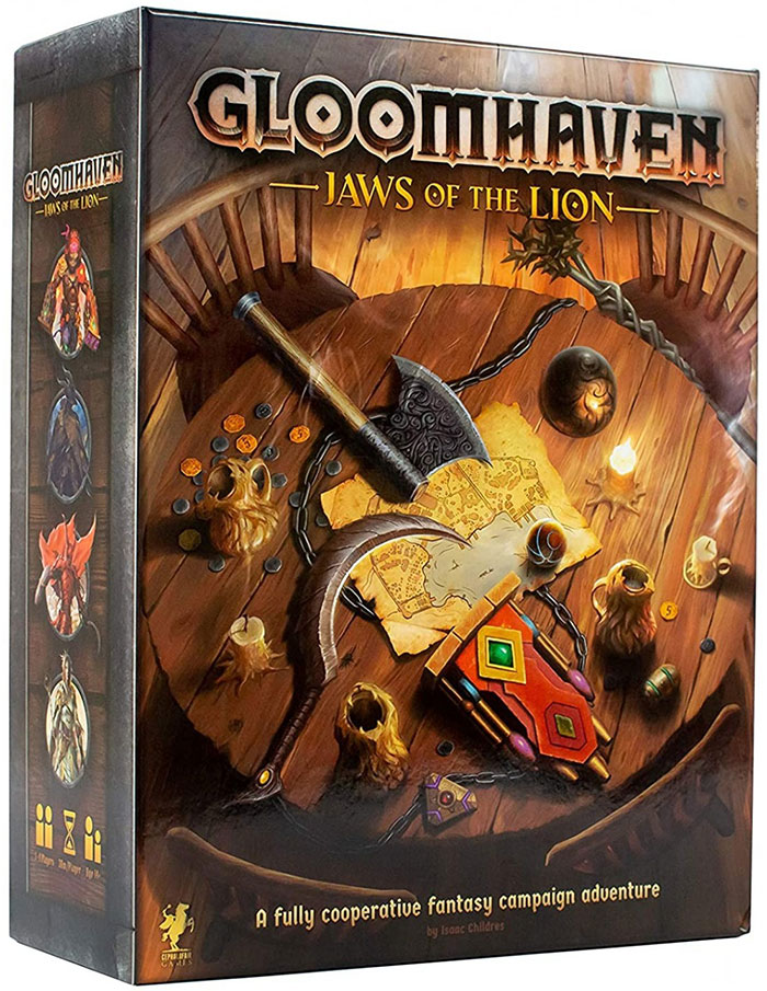 Strategy board game Gloomhaven Jaws of the Lion box featuring fantasy weapons and a map on a wooden table.