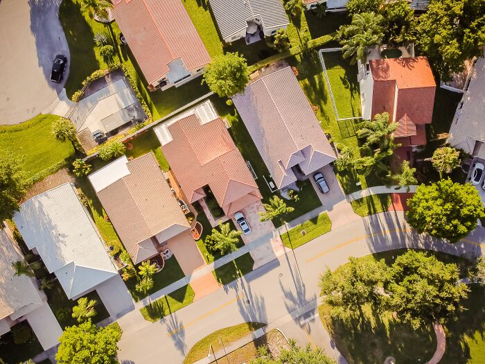 Aerial view of suburban neighborhood with houses and green lawns, reflecting what was actually better in the past.