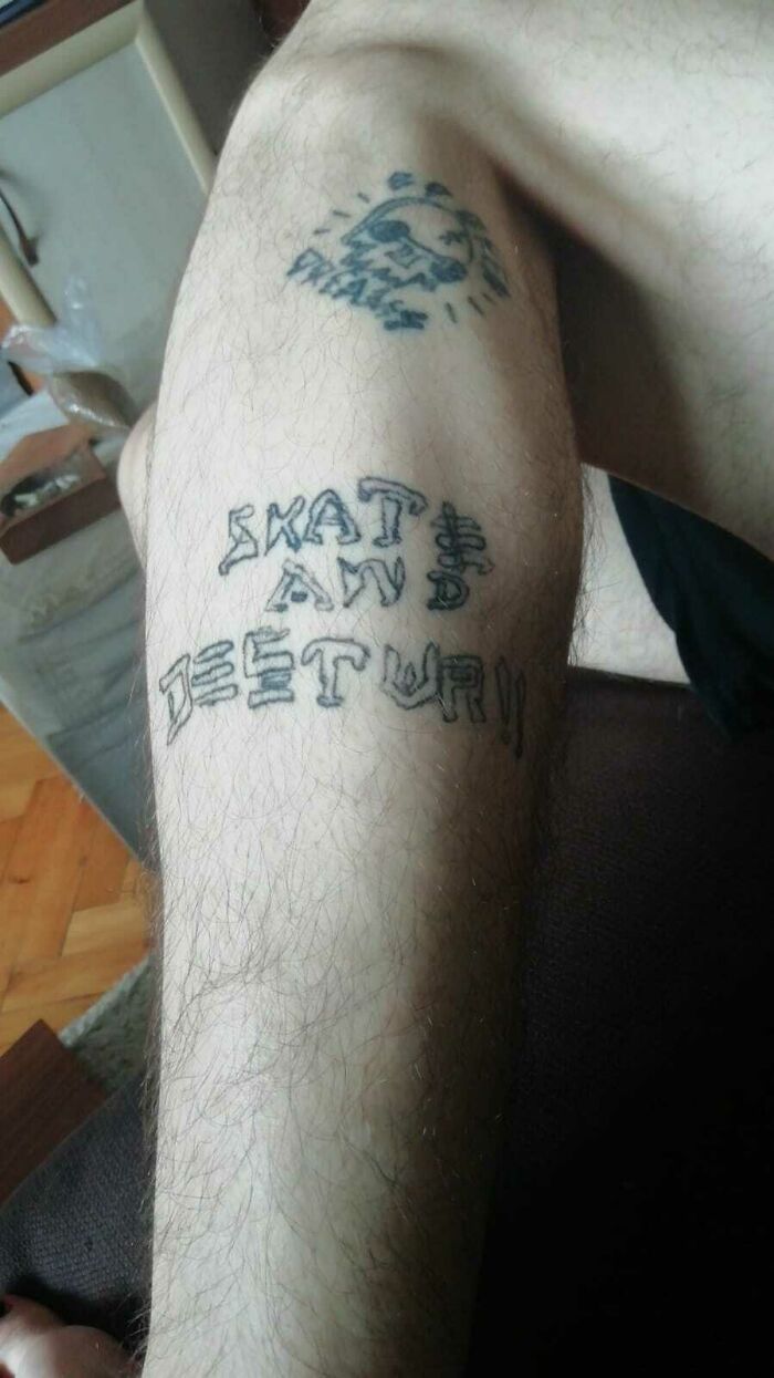 Leg tattoos with text "Skate and Destroy," often considered a red flag in tattoo choices.