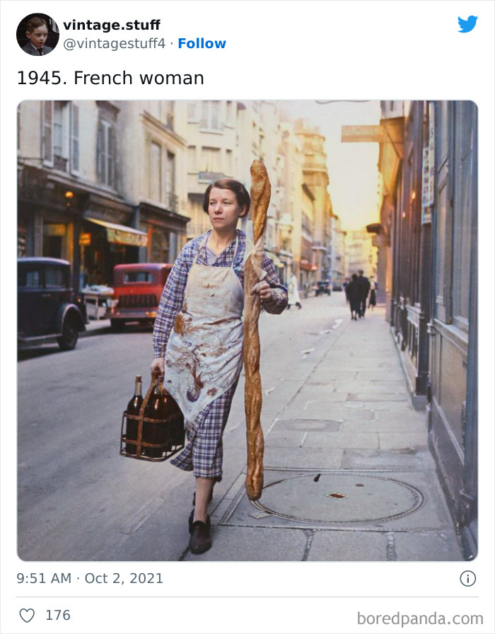Colorized photo of a 1945 French woman carrying a baguette and bottles on a Paris street, showcasing history in vivid detail.