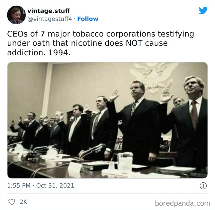 CEOs of tobacco corporations testifying under oath about nicotine a*******n in a historic black and white photo.
