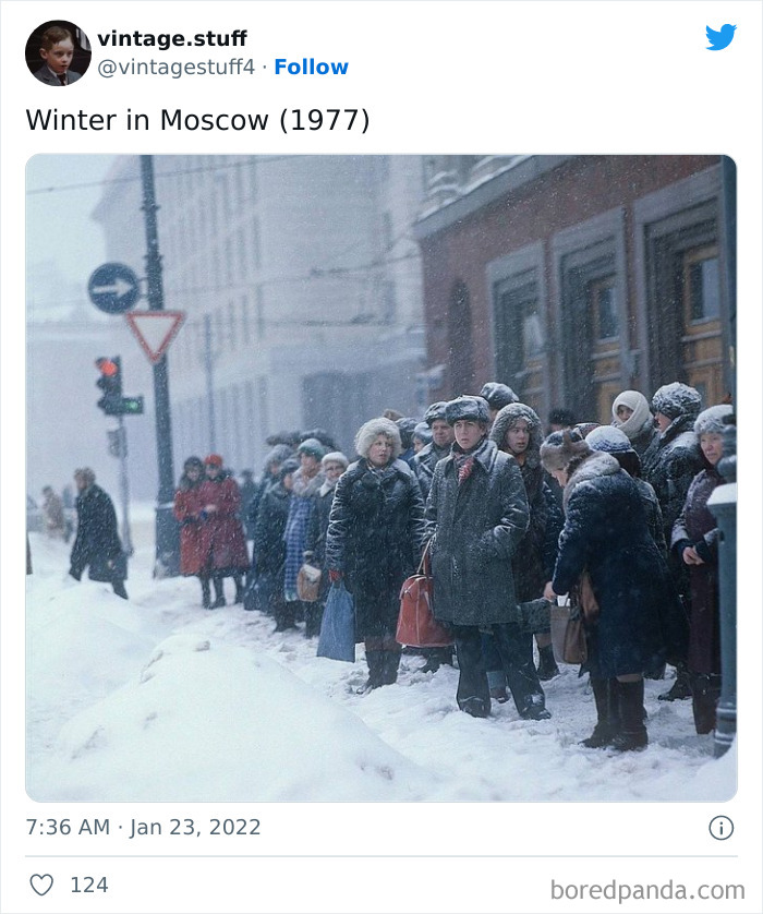 Winter in Moscow 1977 colorized photo showing people in heavy coats and fur hats waiting on a snowy street corner.