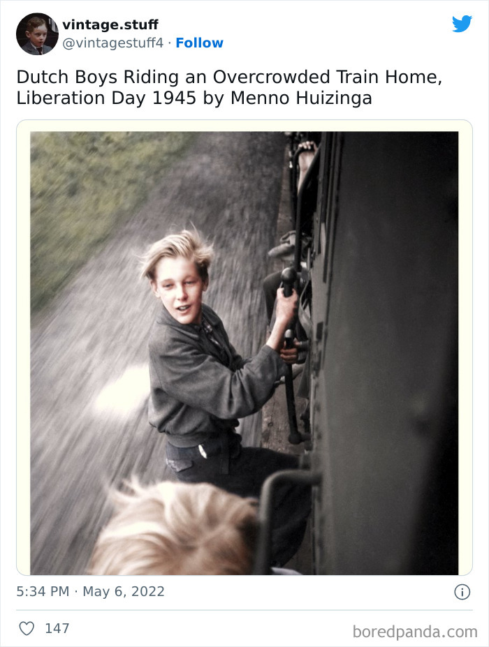 Colorized photo of Dutch boys riding an overcrowded train on Liberation Day 1945 capturing history in stunning detail.