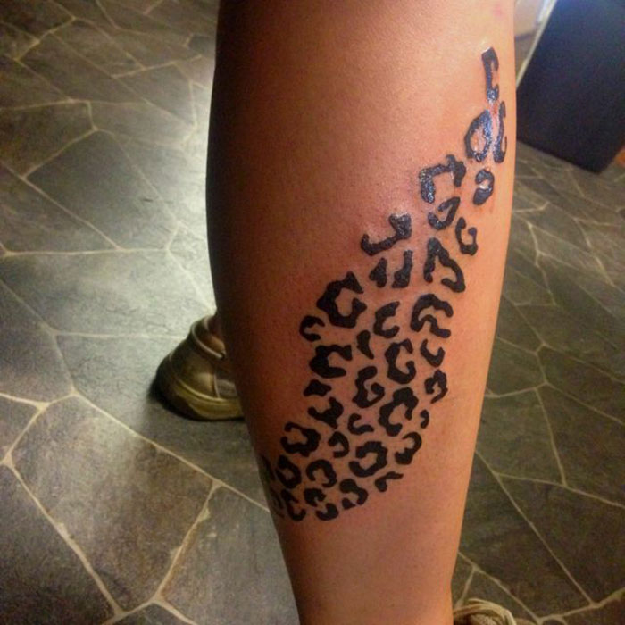 Leopard print tattoo on leg, associated with red flags in tattoos.