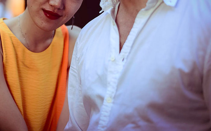 Couple close-up with woman in yellow dress and man in white shirt, highlighting things guys should never say to partners.