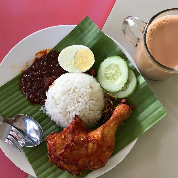 Coconut Rice (Nasi Lemak) With Spicy Sauce (Sambal), Boil Egg,fried Chicken,fried Achovy, Peanut & Cucumber, Additional Milk Tea (Teh Tarik)