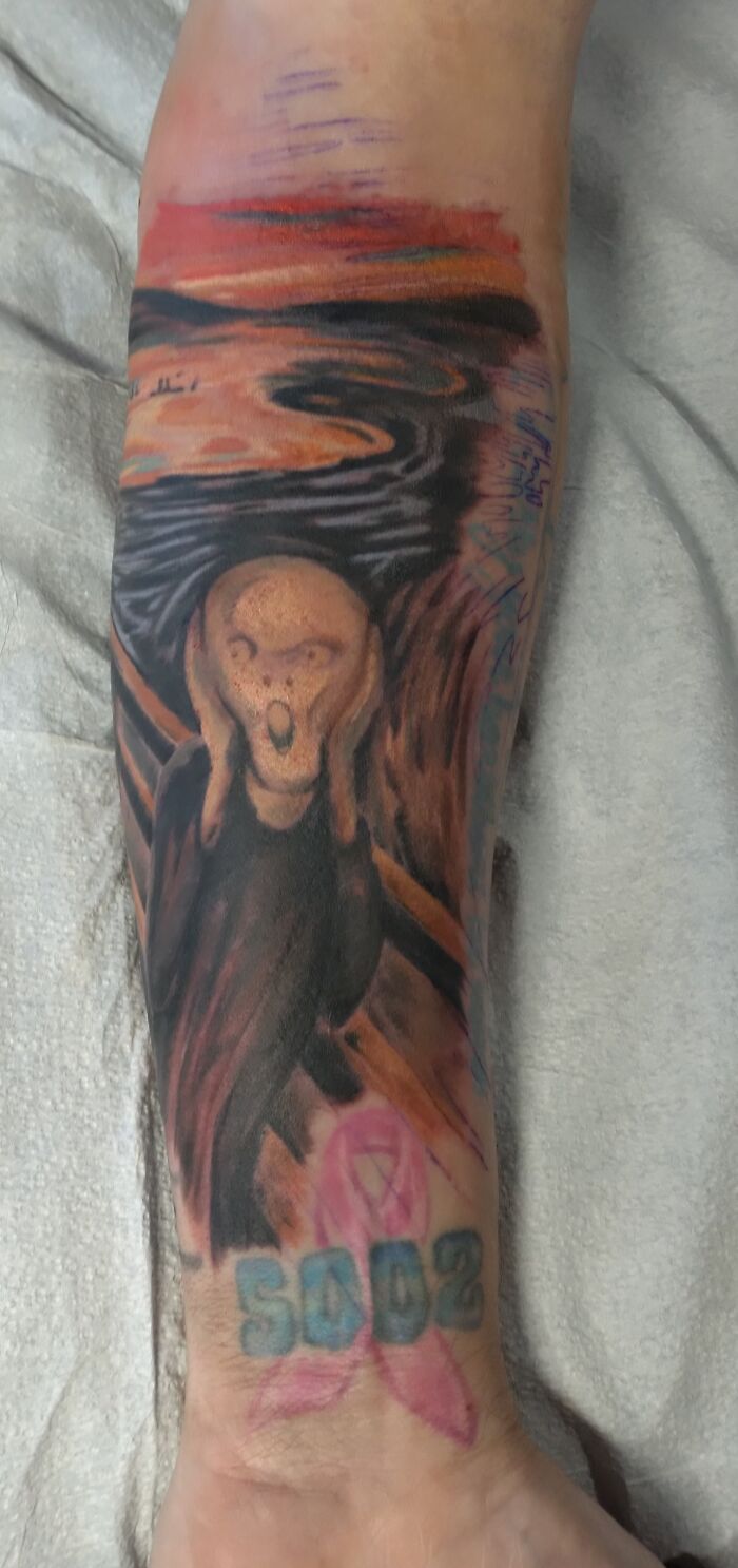 A tattoo of "The Scream" painting with a pink ribbon and "SAD2" text.