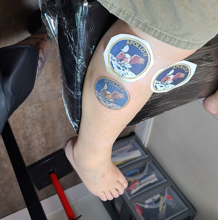 Apollo mission patches tattoo on leg with three colorful designs featuring an eagle and moon.