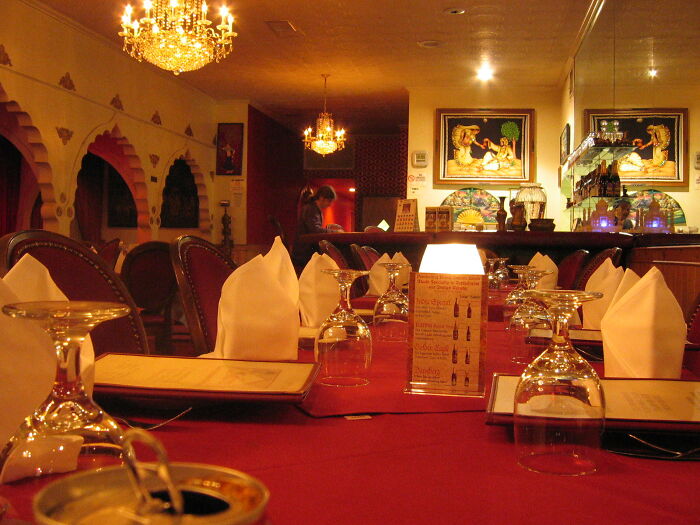 Elegant restaurant interior with a romantic ambiance, highlighting table settings and decor for couples and partners.