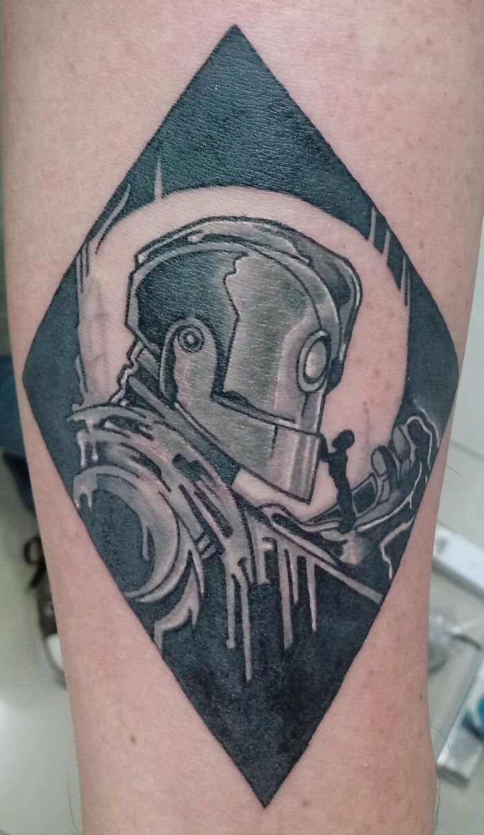 Robot-themed tattoo with geometric shapes on skin; part of a tattoo collection.