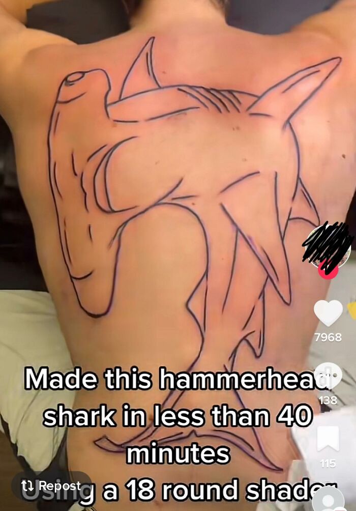 Back tattoo of a hammerhead shark with bold outlines, criticized online in a Facebook group for horrible tattoos.