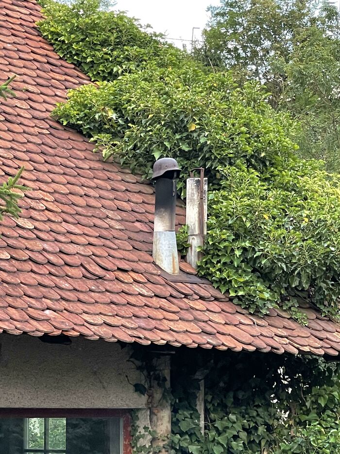 My Neighbor’s Auto Repair Shop Has A WW2 German Helmet For A Chimney Cover