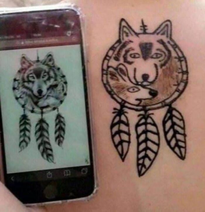 Bad tattoo of a wolf dreamcatcher compared to a better design on a phone screen.