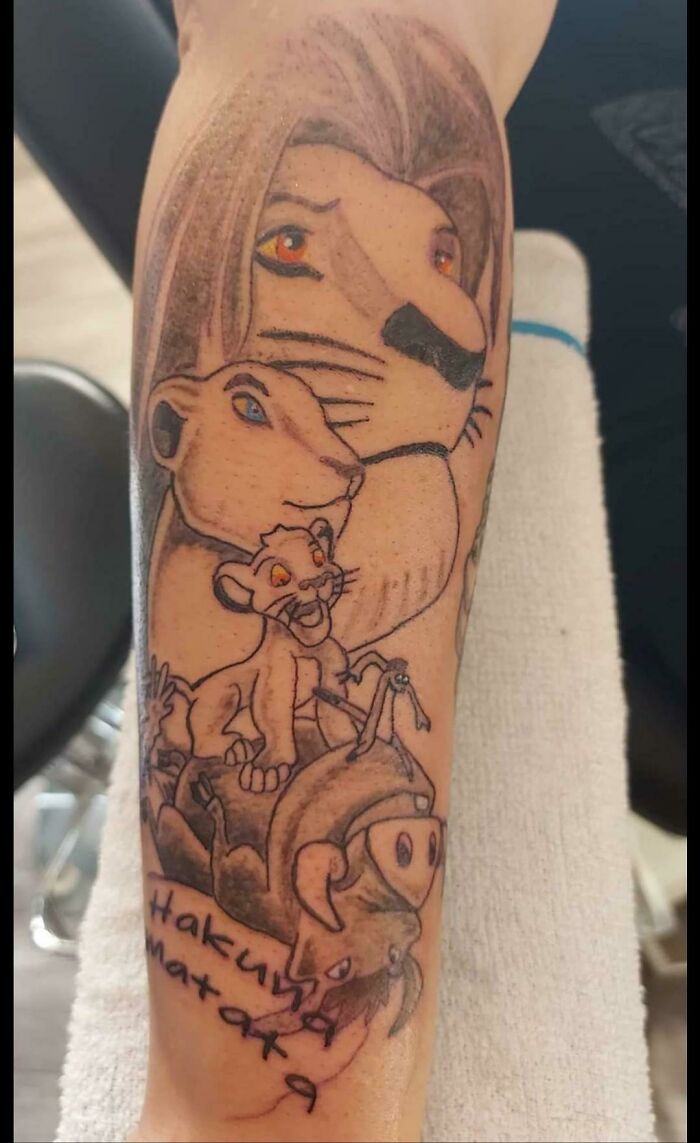 Tattoo of cartoon lions and "Hakuna Matata" text on arm, shared in online group for worst tattoos.