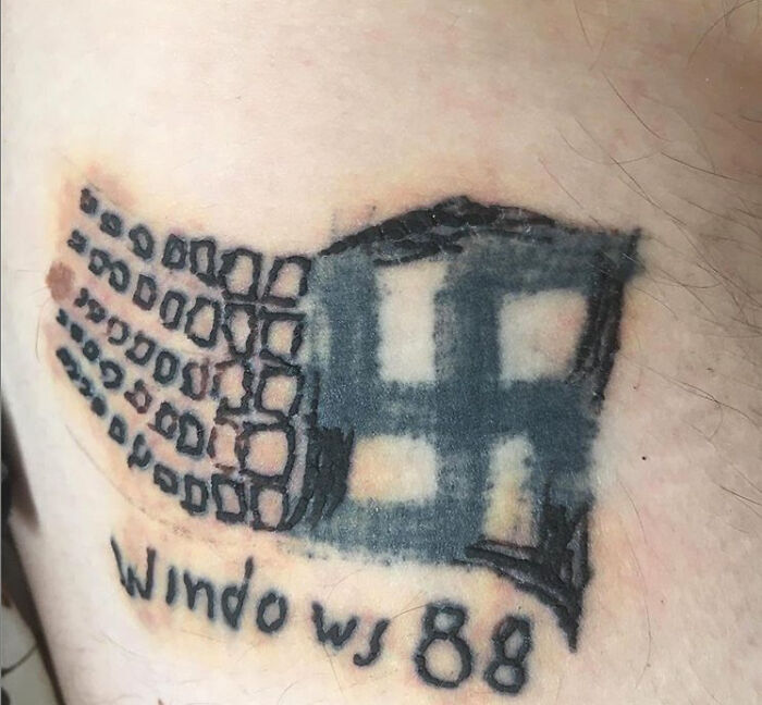 Tattoo of a distorted Windows 98 logo on skin, representing one of the worst tattoos shared online.