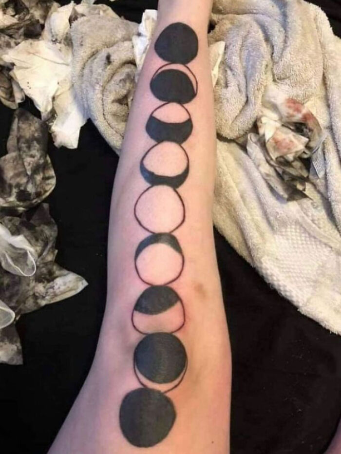 Arm tattoo with black geometric shapes, possibly seen as one of the worst design choices.
