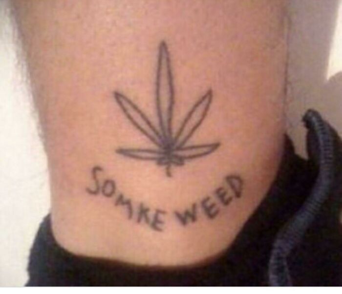 Tattoo of a cannabis leaf with misspelled text, illustrating one of the worst tattoo designs.