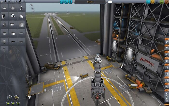Space rocket being assembled in a hangar with control panels visible, related to top indie games in development.