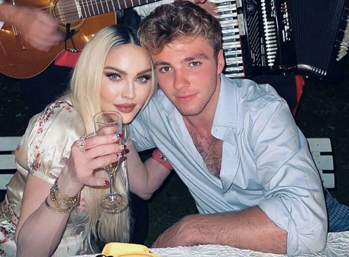 A young couple posing closely at a party, illustrating Instagram reality community exposing fakest photos online.