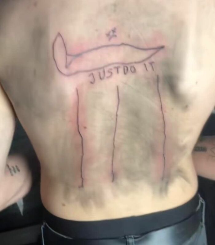 Poorly drawn tattoo of a shoe with "Just Do It" on a person's back, representing horrible tattoo ideas shamed online.