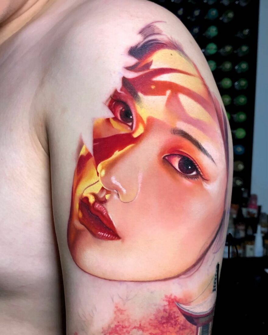 Hyper-realistic tattoo of a woman's face on a person's arm, featuring vibrant colors and intricate details.