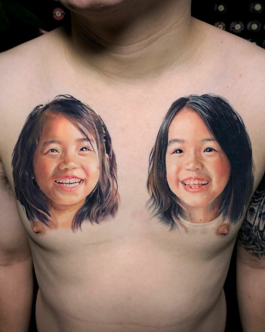 Hyper-realistic tattoos of two children's faces on a person's chest.