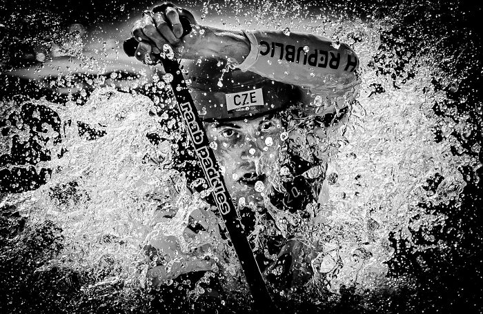 Athlete in intense water sports action, captured with dynamic water splashes in World Sports Photography Awards nomination.