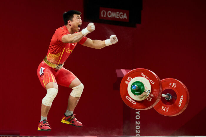 Weightlifter from China celebrating a lift during a key moment in sports nominated by World Sports Photography Awards.