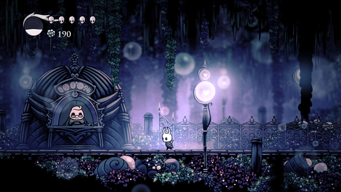 Screenshot from an indie game featuring a small character in a dark, mystical forest with glowing lights and fantasy elements.