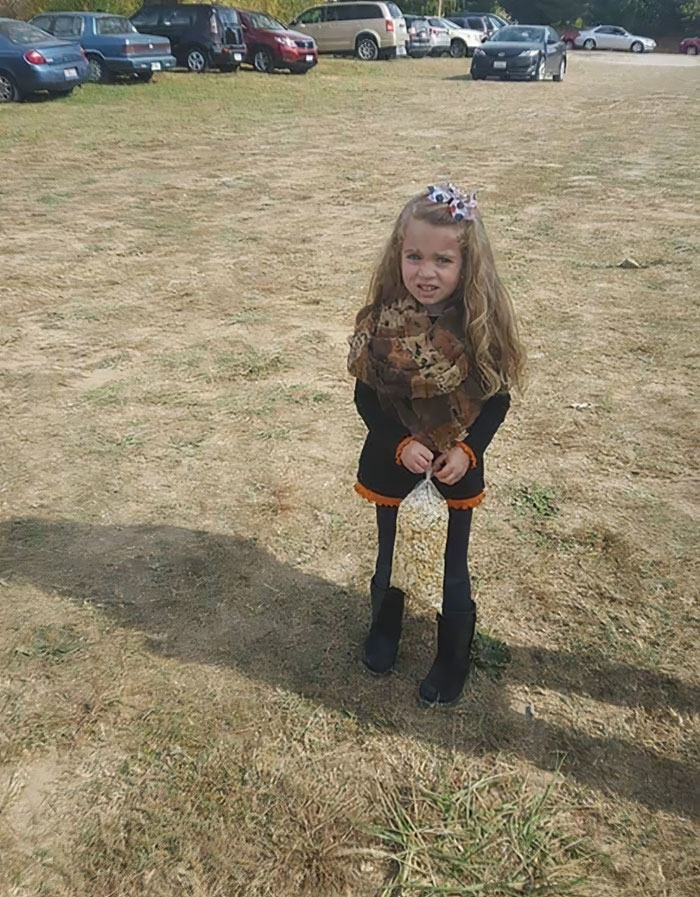 Young Girl Posing With A Bag Of Popcorn