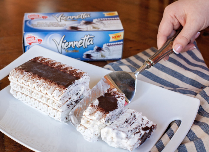 Viennetta dessert being sliced on a plate, capturing nostalgic 90s foods vibe.