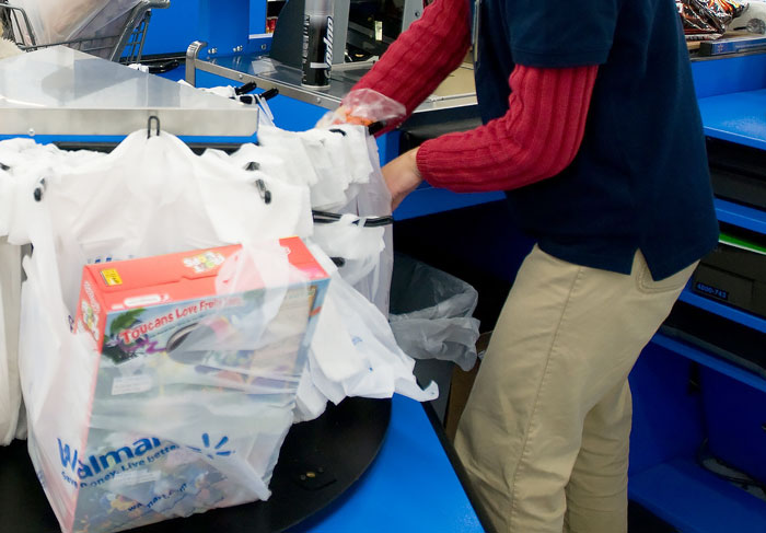 Person using a supermarket self-checkout, highlighting legal concerns from a criminal defense perspective. - 2