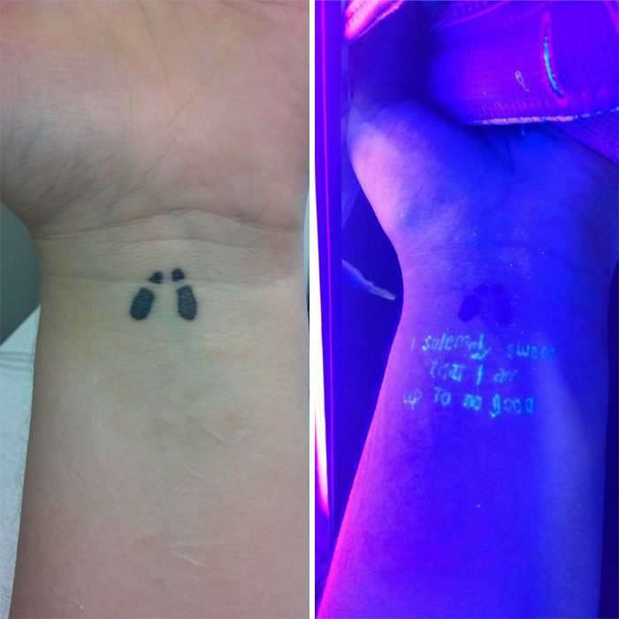 Harry Potter tattoo with footprints and glowing text under UV light on wrist.