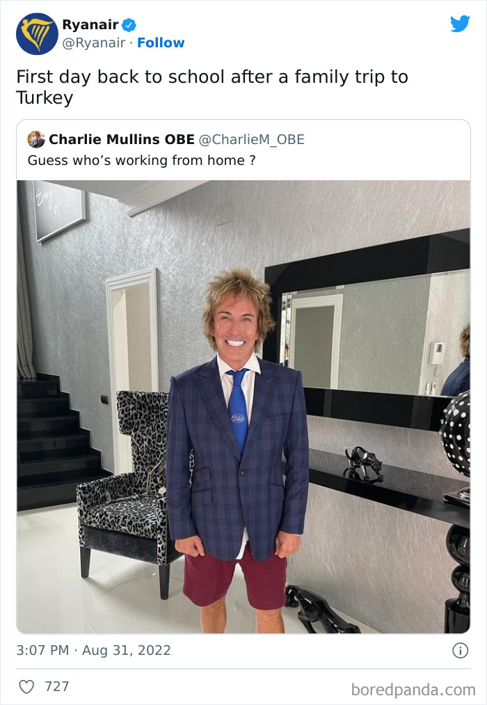 Man in blue blazer, blue tie, and red shorts smiling indoors, part of savage Ryanair social media roasts humor.