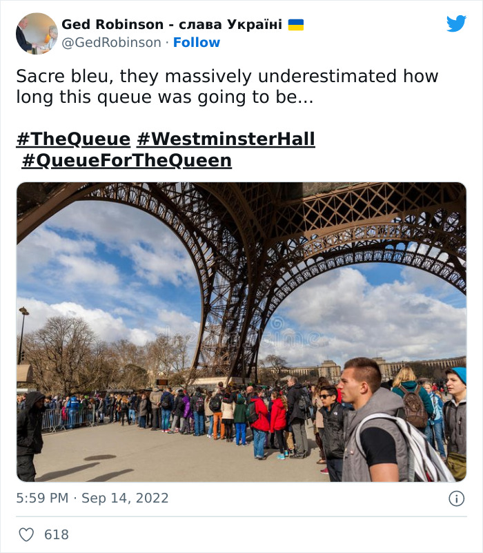 Long queue of people waiting outdoors under a large iron structure, illustrating the British queue for the Queen in London.