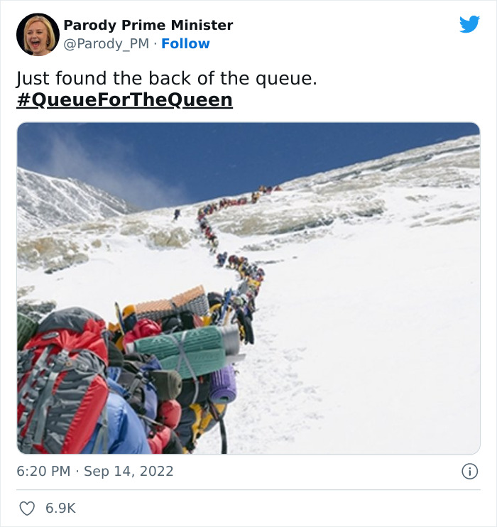 Long line of hikers climbing snowy mountain humorously representing the very British queue for the Queen at Westminster.