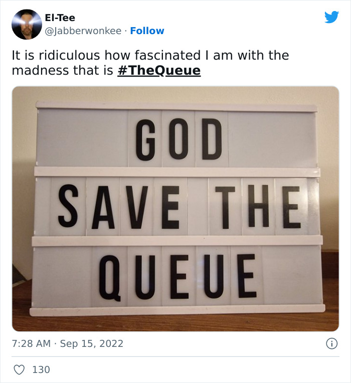 Lightbox sign displaying the phrase God Save The Queue referencing British queue memes and reactions in London.