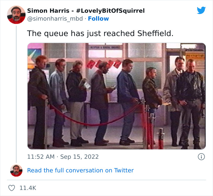 People standing in a very British queue, waiting indoors, illustrating memes and reactions to the London queue for the Queen's viewing.