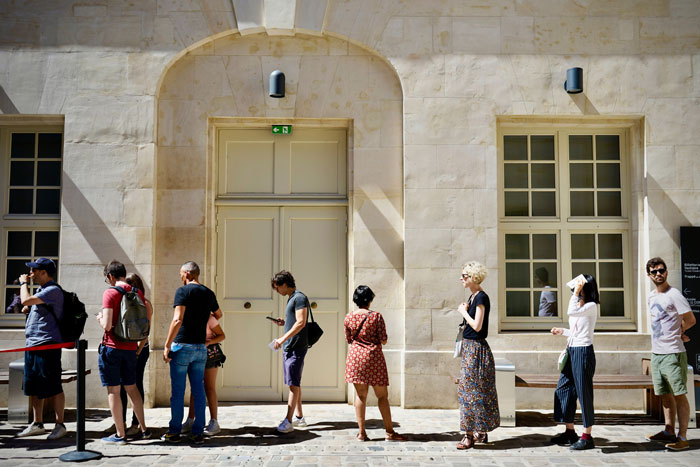 People waiting in the line on the street