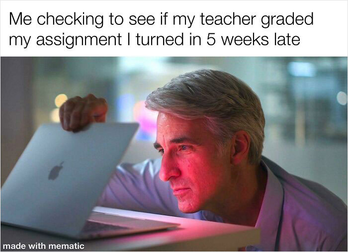 Man intently peering at a laptop screen, capturing the funny school meme about checking grades for a late assignment.