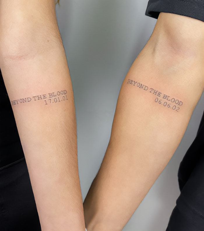 Simple brother and sister tattoos reading "Beyond the Blood" with birth dates on forearms.
