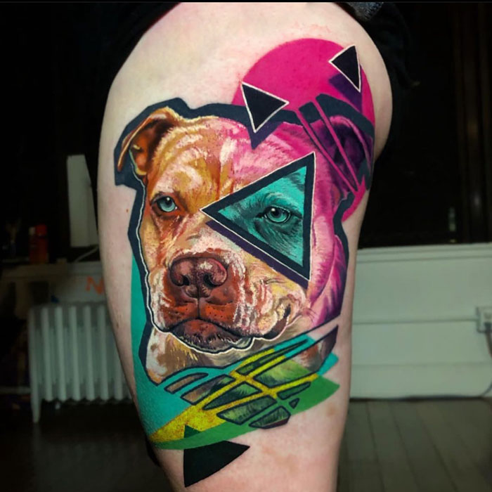 Colorful geometric pet tattoo featuring a dog's face, celebrating furry friends.