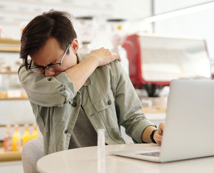 Man sitting and sneeze
