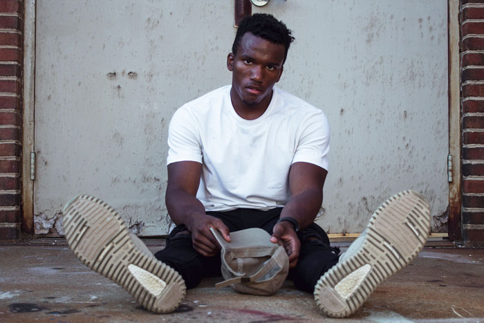 Man sitting and wearing white shirt