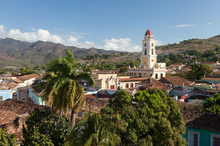 Scenic town view with historic buildings and palm trees under blue sky, illustrating things you may not think of doing crime risks.