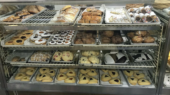 Bakery display case filled with assorted pastries and cookies, illustrating entertaining it doesn't work like that stories.